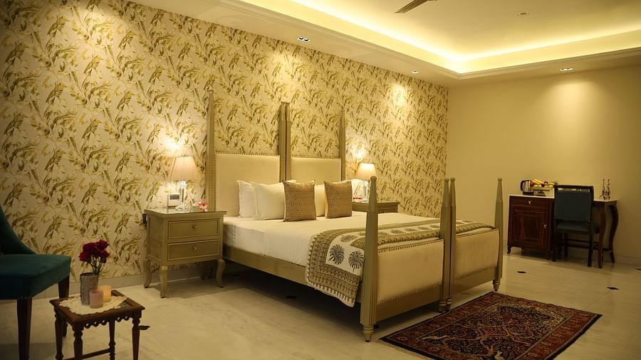 A room at Dileep Kothi, Jaipur with a double bed, side tables and a coffee table arrangement